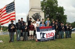 Members of the 1st Minnesota Volunteer Infantry reenactors, Minnesota Civil War Commemoration Task Force, and the four student winners of the Minnesota Historical Society's "Dear President Lincoln" student writing contest, pose for a photo at the 1st Minnesota Monument at Gettysburg on July 2, 2013.