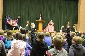 School children at Black Hawk Middle School in Eagan, Minn., raise their hands and wait for President Abraham Lincoln, portrayed by Max Daniels, to call on them to ask a question during the Nov. 19 presentation. The one-day lecture series was sponsored by the Minnesota Civil War Commemoration Task Force. (Photo by Jeffrey Williams/Minnesota Civil War Commemoration Task Force)