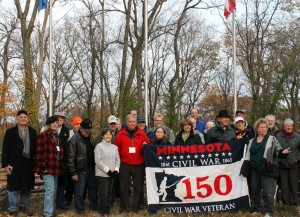 Approximately 40 Minnesotans who attended the Nov. 16 ceremony take a group photo on the summit of Shy's Hill.
